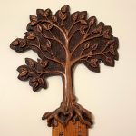 carving of a tree on top of a family growth chart