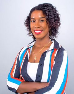 Dr. Stephanie Toliver, a woman with short curly hair, with her arms crossed, wearing a multicoloured shirt