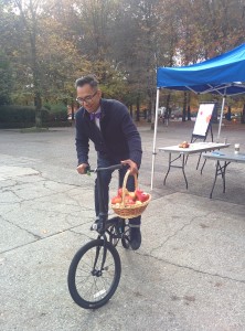 Alden Habacon, Intercultural Understanding Director, is making a fresh apple delivery on his bike.