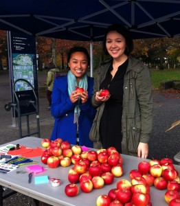Joanna and Krystal of the Equity & Inclusion Office handing out apples. 