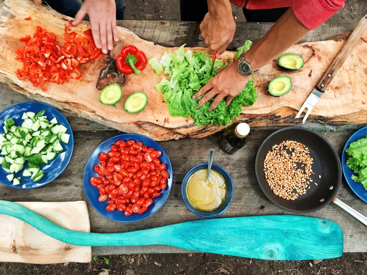Photograph of people chopping vegetables