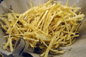 deep-fried tortilla strips being drained on paper towel