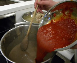 adding the tomato mix to the pureed beans for the Sopa Tarasca