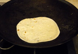 cooking the tortilla on a 'comal'