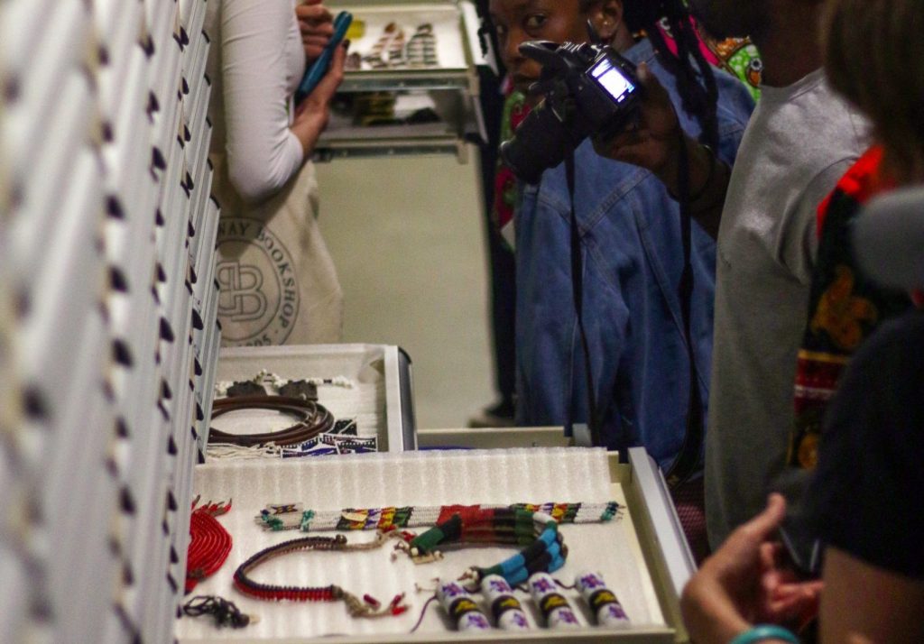 Image of workshop participants opening drawers with belongings at Iziko Museums