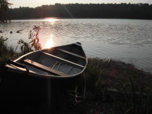A canoe on a lake at sunrise