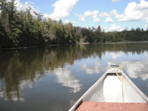 The bow of a canoe on a lake