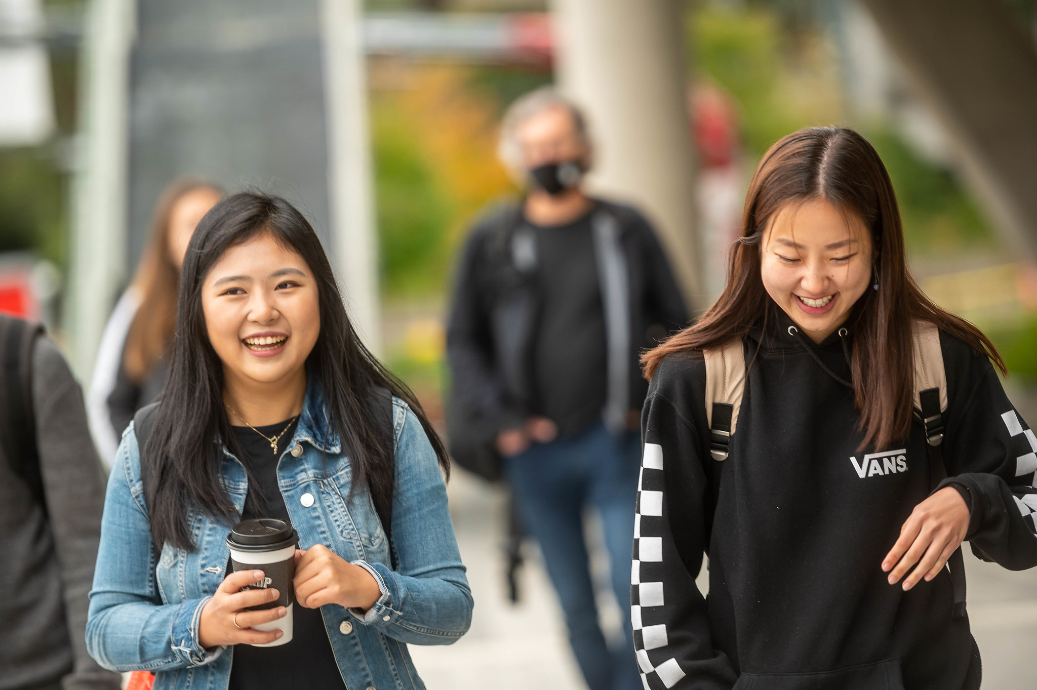 Two students walking and laughing