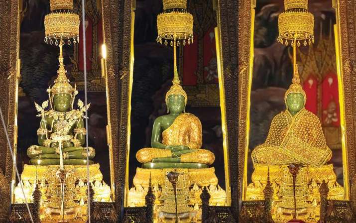 Image of Emerald Buddha Statue in three ceremonial gold garments.