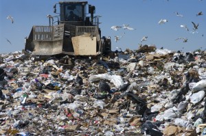 Truck moving trash in a landfill