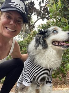 Celeste and her dog in matching black and white outfits.