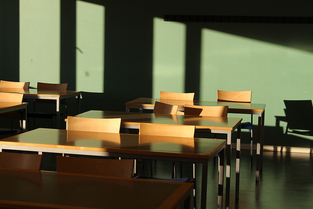 photo of a classroom with empty desks and chairs