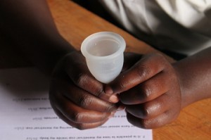 A menstrual cup is passed around the workshop for femmeinternationale.