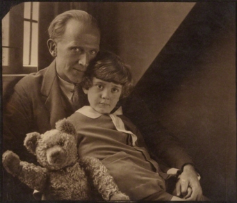 A famous and iconic photograph by Howard Coster of A.A. Milne, his son Christopher Robin and Pooh Bear at Cotchford Farm, their home in Sussex, dated 1926 and in the collection of the National Portrait Galley, London, a gift of the estate of Howard Carter 1959.