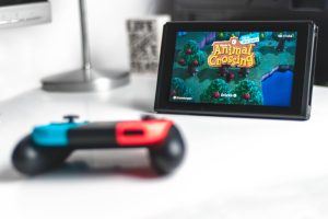 Photo of a Nintendo Switch with Animal Crossing:New Horizon's home screen.