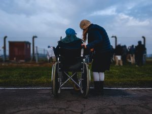 Wheelchair user with friend unable to view what others in front are seeing due to inaccessibility