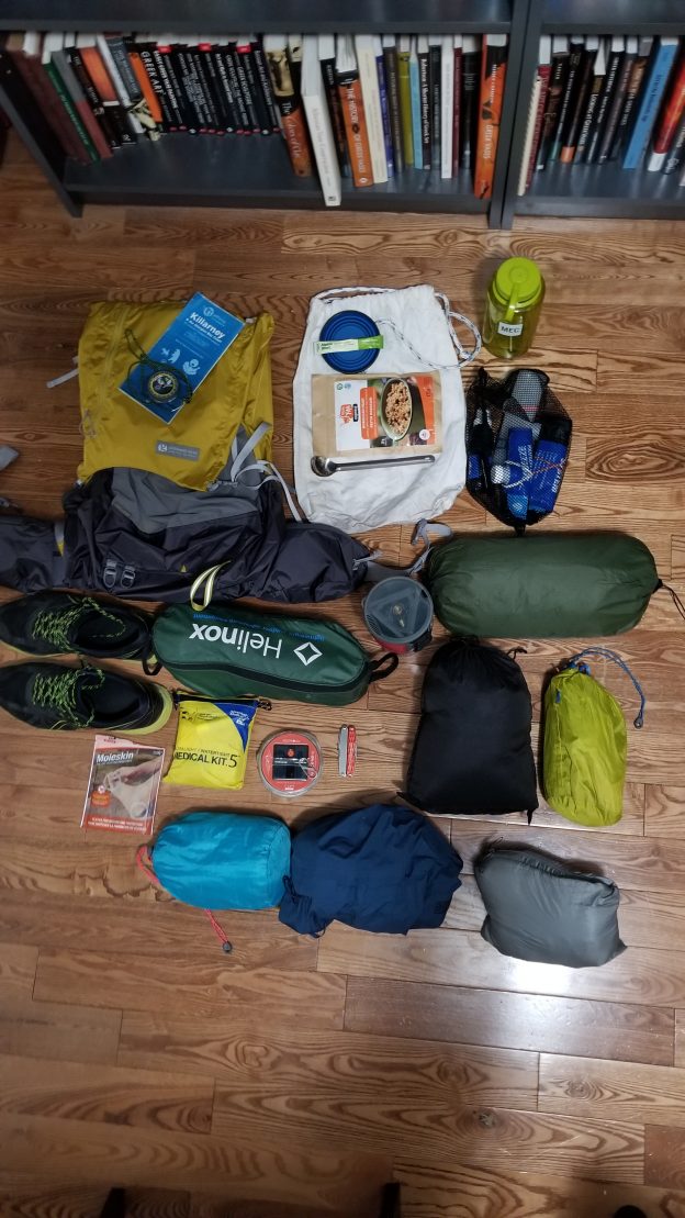 Backpack accompanied by items used in hiking.