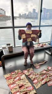 photo of person holding up pieces of sewn squares for a quilt