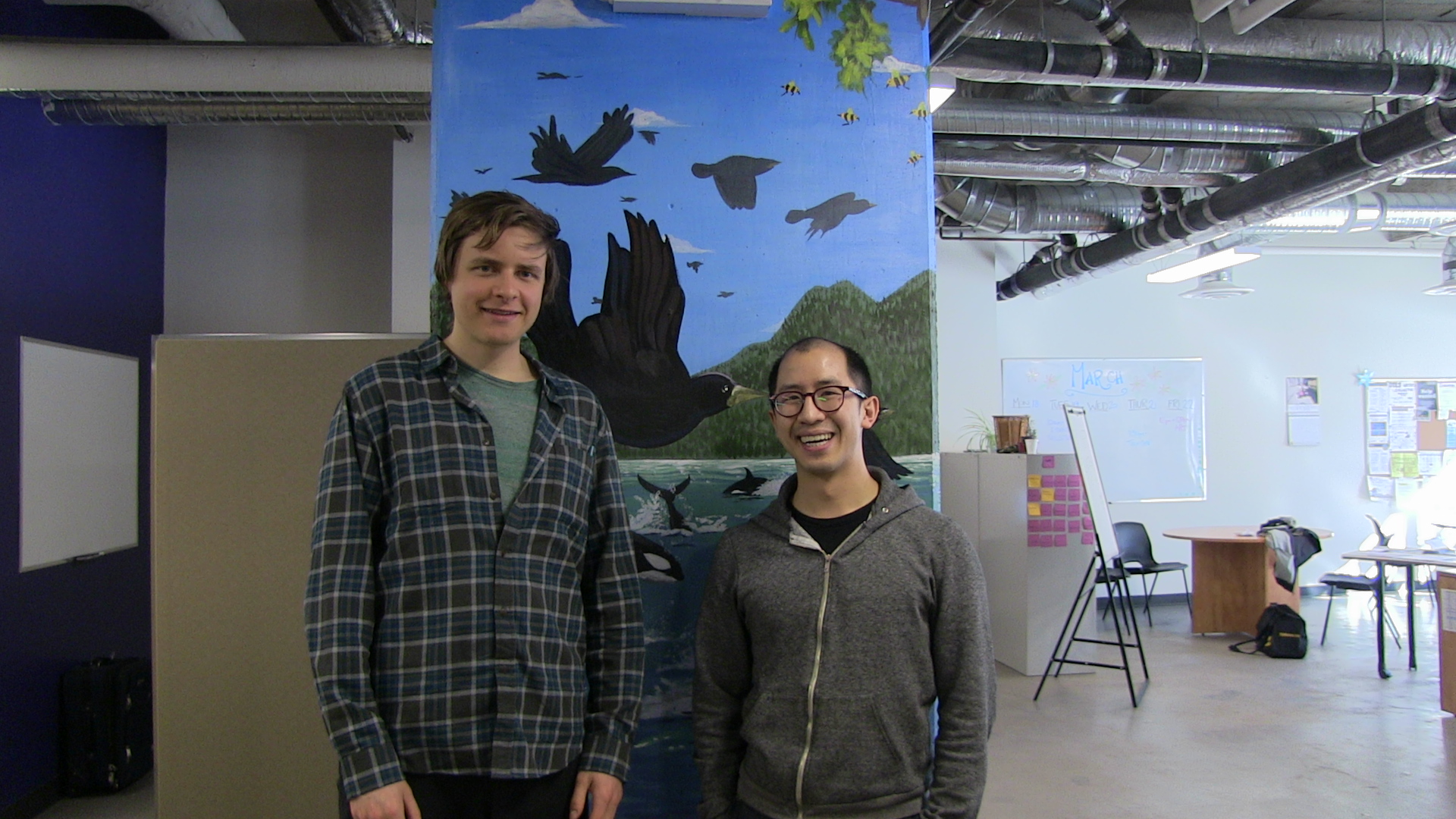 Austin and Brandon, males, standing in front of pillar