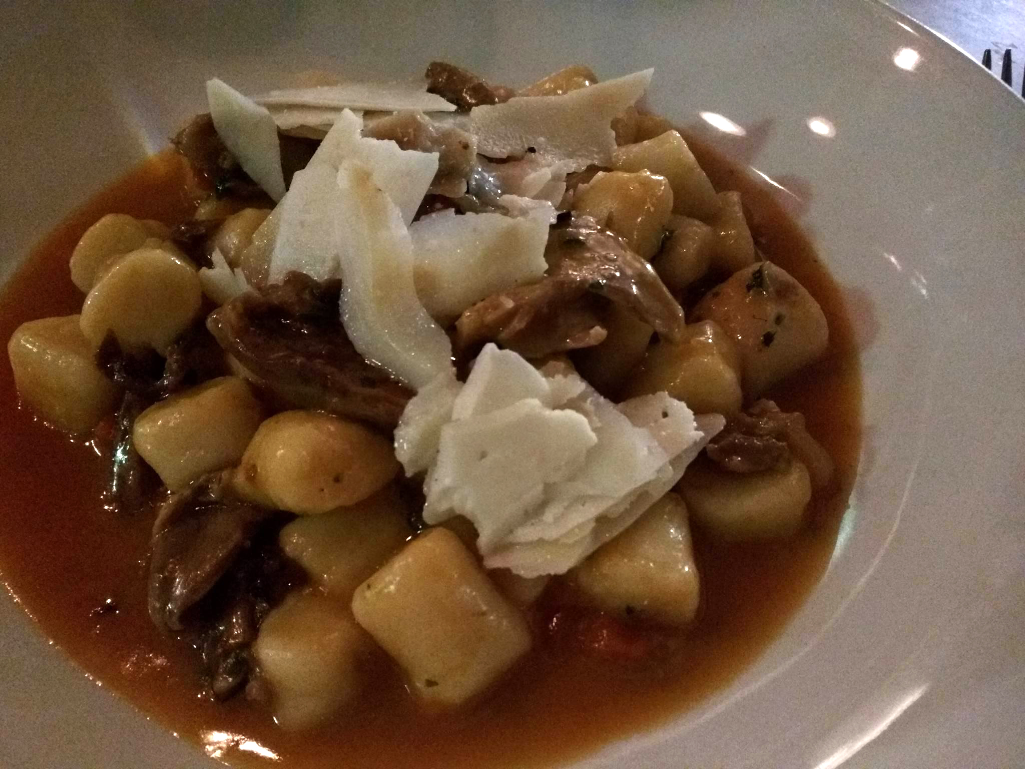 Gnocchi and braised duck breast with shaved Parmesan in  porchini mushroom sauce.