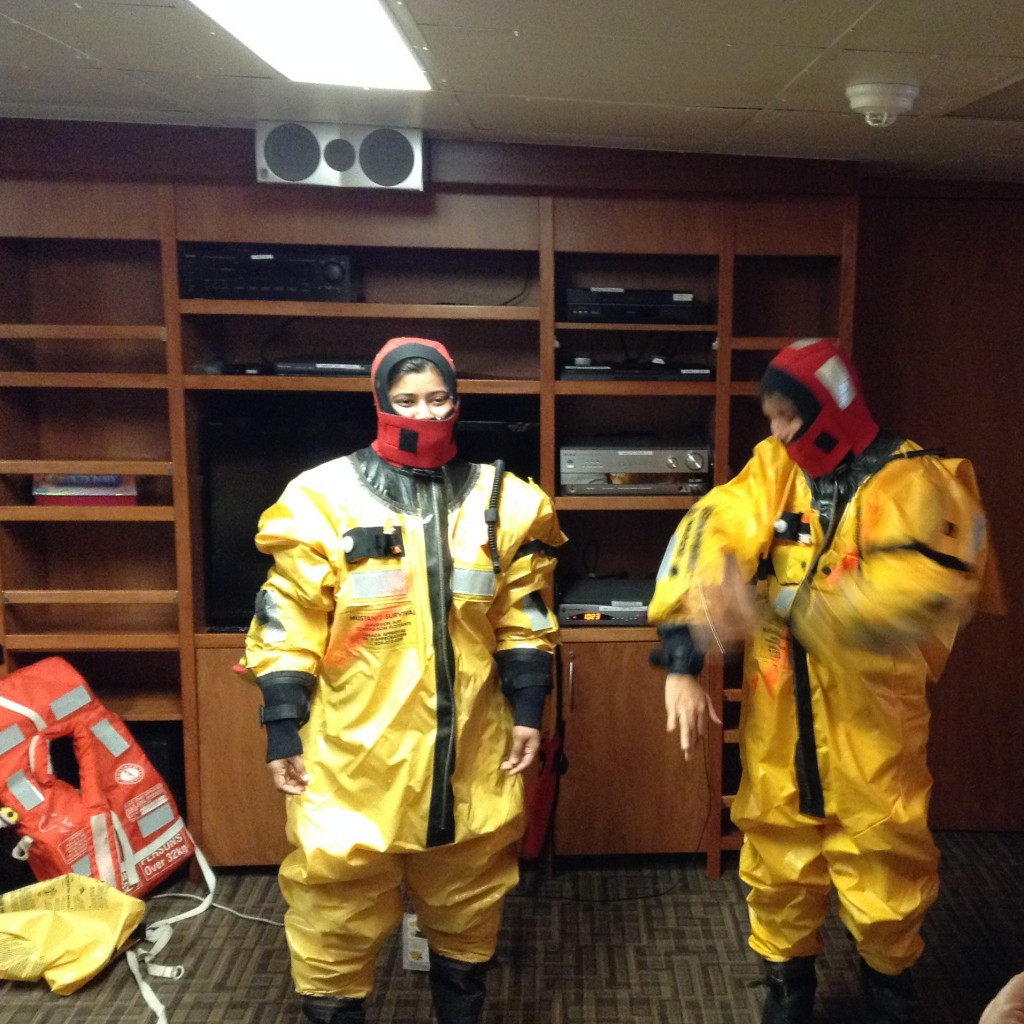 Donning immersion suits.