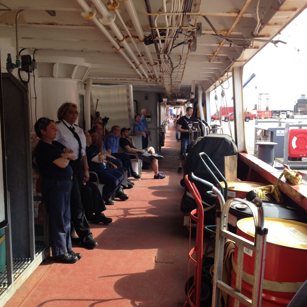 The crew of the Amundsen on deck to watch us embark from land. 