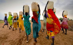 Image from Irish Aid Website showing a group of women carrying water. https://www.irishaid.ie/what-we-do/who-we-work-with/civil-society/civil-society-overview/