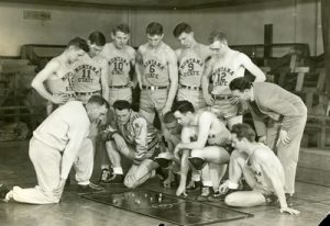 basketball_team_in_romney_gym_studying_plays