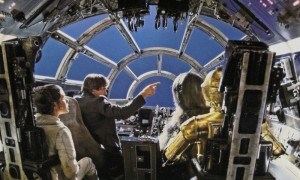 View from the back of the Millennium Falcon cockpit set with the back removed for camera placement to shoot the set and actors against a blue screen to be filled with space environments in post-production. © Lucasfilm Ltd. and TM. All Rights Reserved.