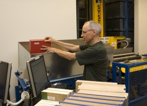 Ernest Dick, Library Assistant, loads the commemorative one millionth title into the ASRS. Photo by Jill Pittendrigh.