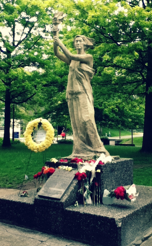 The Goddess of Democracy with flowers at her feet, in memory of June 4, 1989