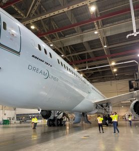 Up-close airplane in a hangar, a Boeing 787-9 Dreamliner.
