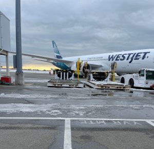 A plane and some equipment sits on the apron.