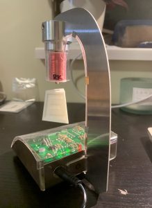 Student-made magnetic levitation device that levitates a miniature version of the UBC Engineering Cairn. The circuit board and magnetic coil is visible.