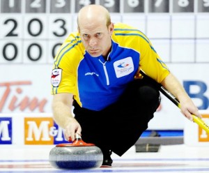 Alberta skip Kevin Martin throws a rock against Saskatchewan during the 12th draw at the Brier curling championships in London