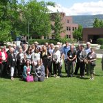 The 30 participants in the community partners' meeting pose for a group photo in the sun at UBC Okanagan campus.