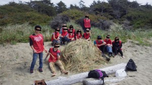 The students from Ukee Secondary with their gigantic pile of dead grass.