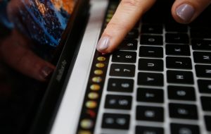 A guest points to a new MacBook Pro during an Apple media event in Cupertino, Calif., on Oct. 27