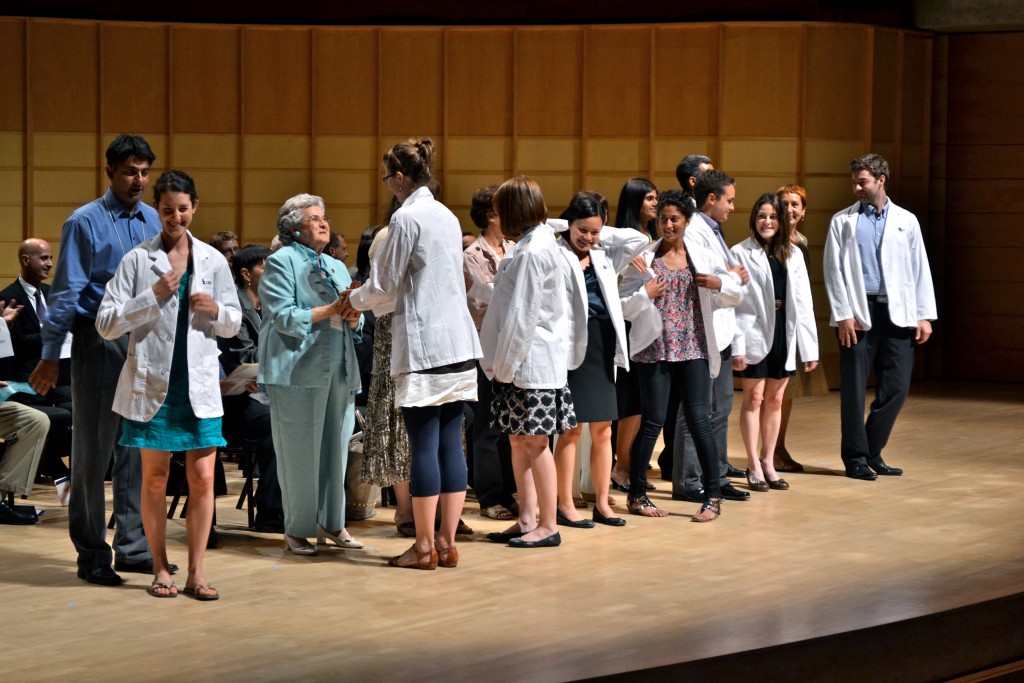 Students on stage at the Chan Centre receiving their white coats at the 2012 White Coat Ceremony.