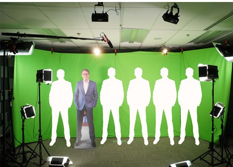 A picture showing that the greenscreen is wide enough to fit six people.