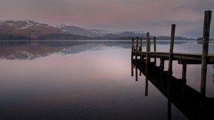 The pier at Derwentwater on a still calm winters day at sunrise.