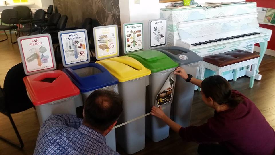 Paul teaching Sandra how to place the decals on the bins