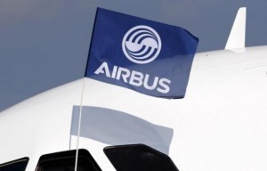 A flight test engineer holds an Airbus Group flag after the first flight of the Airbus A320neo in Colomiers near Toulouse