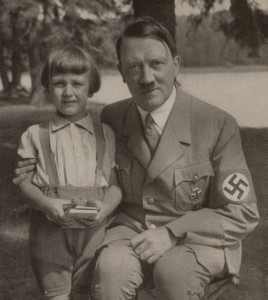 Adolf Hitler, leader of the Nazi party, pictured here with a young child during World War II.